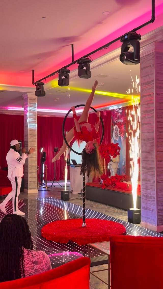 Aerial performer at a celebration with red lighting
