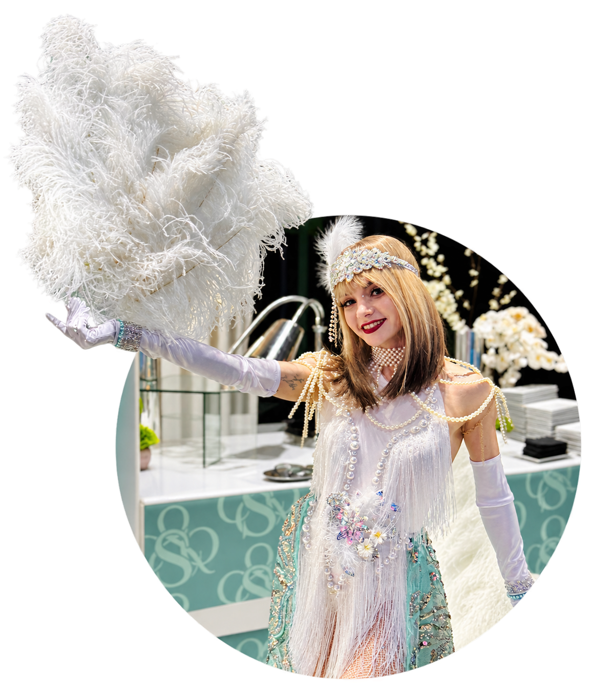 Costumed host in white with pearl details holding a large white feather fan