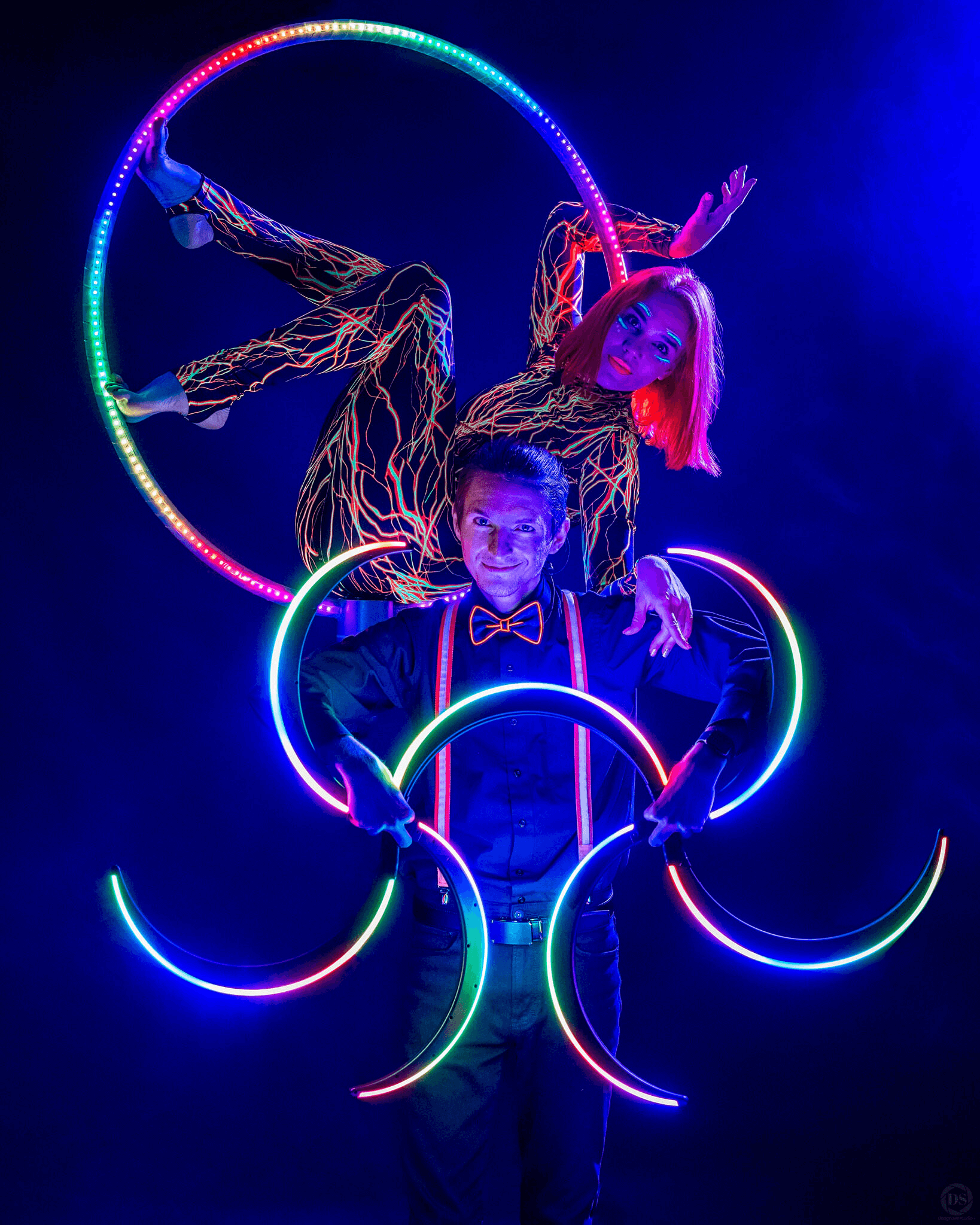 Liza and Danila performing with an aerial hoop and illuminated rings